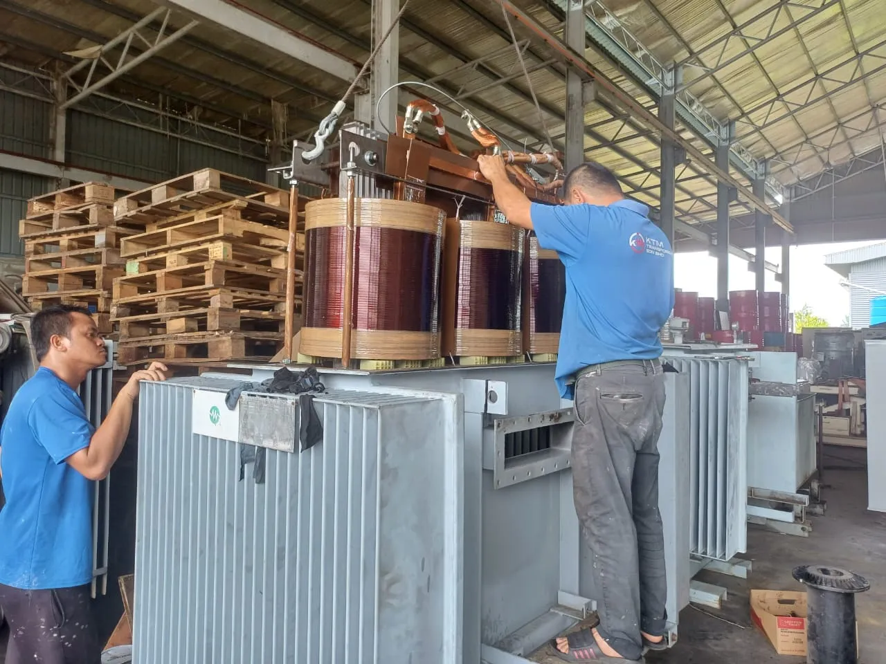 A transformer active part being lowered back into its tank.