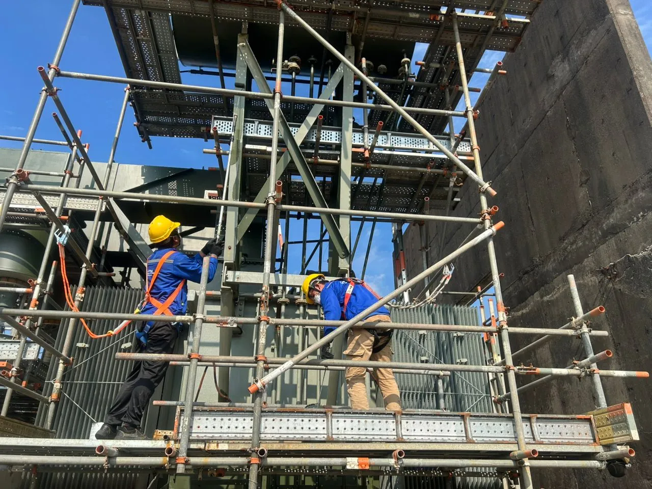 KTM Transformers technicians working from scaffolding at the Bintulu power station.