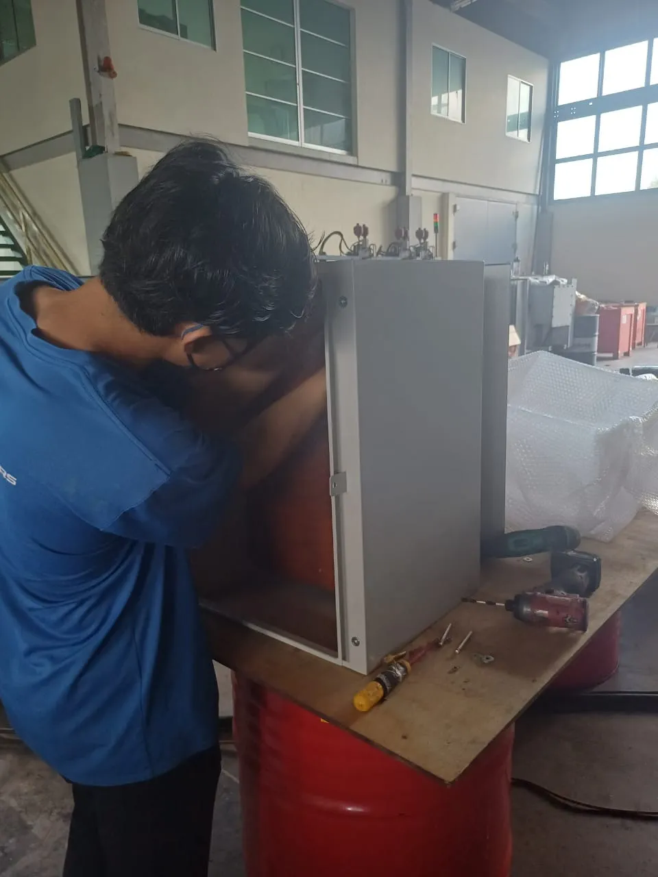 An electrical cabinet being assembled in the workshop.