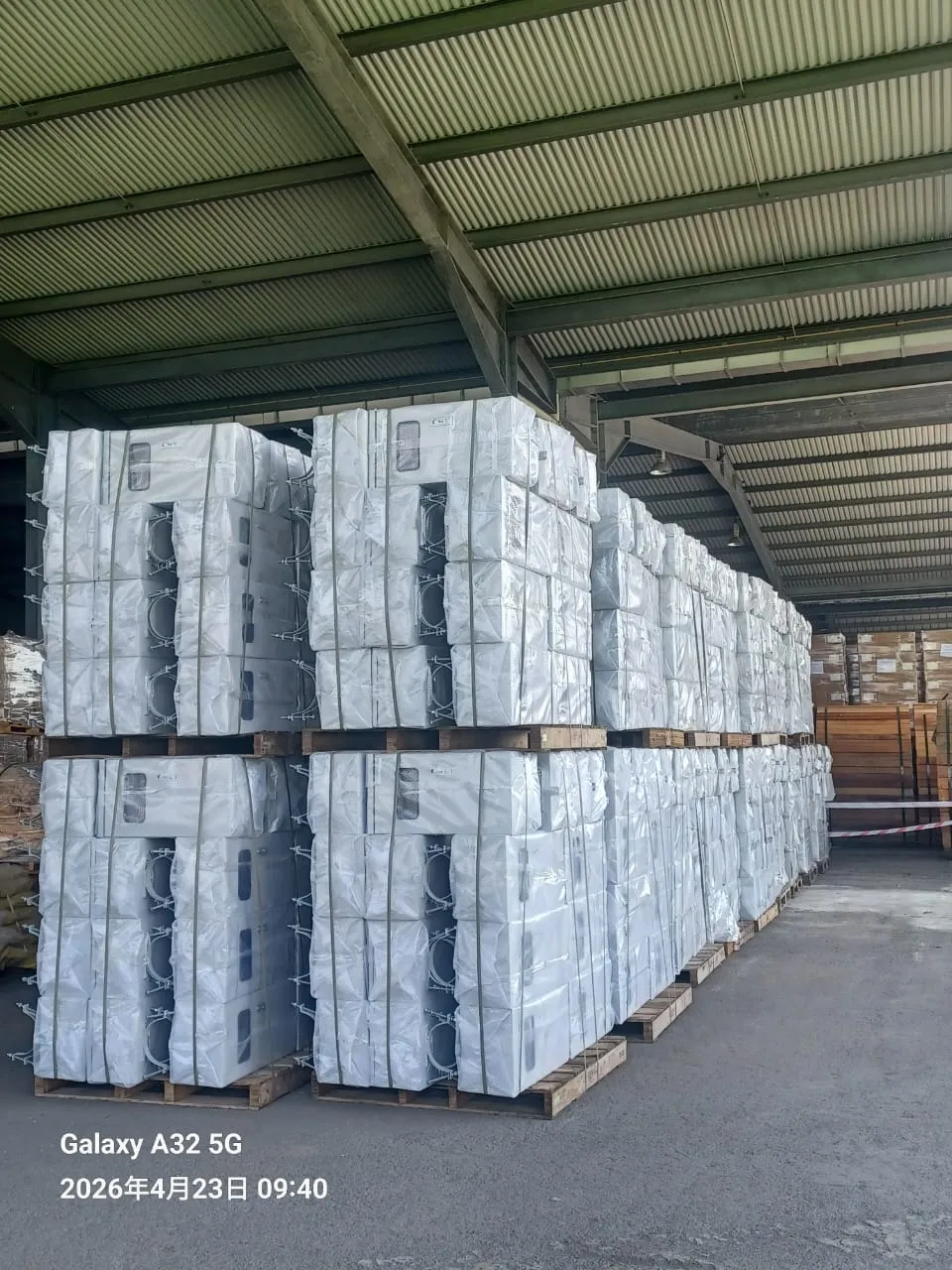 Batches of fabricated control cabinets stacked in the workshop.