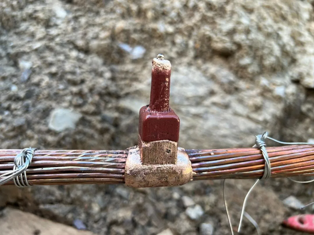 A completed exothermic weld bonding copper earthing conductors.