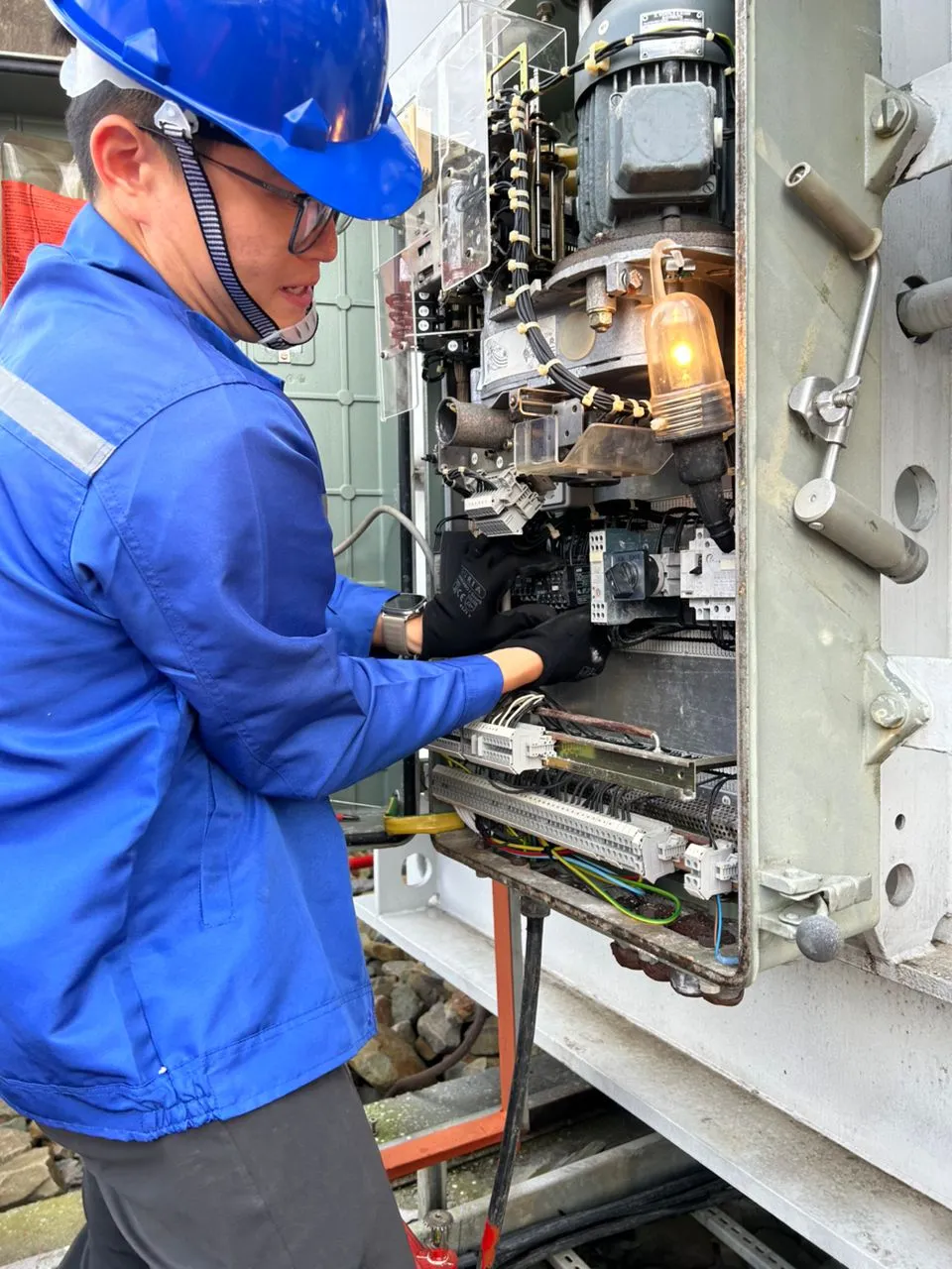 A KTM technician servicing an on-load tap changer mechanism.