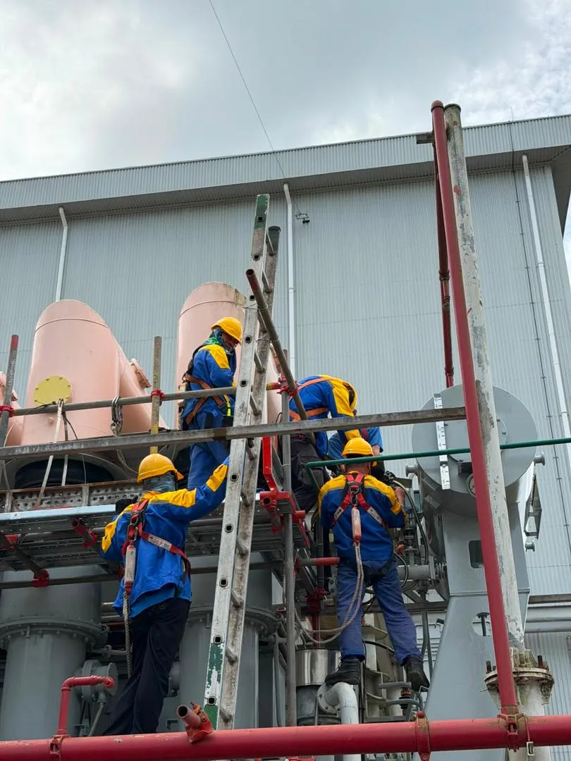 KTM Transformers technicians working from a scaffold in full harnesses on a transformer bank.
