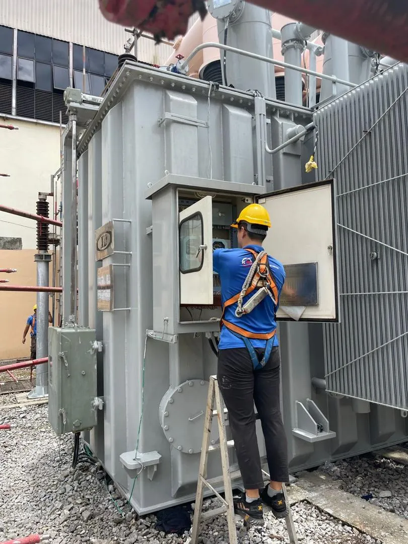 A technician working on a transformer marshalling cabinet at Sejingkat Power Corporation.