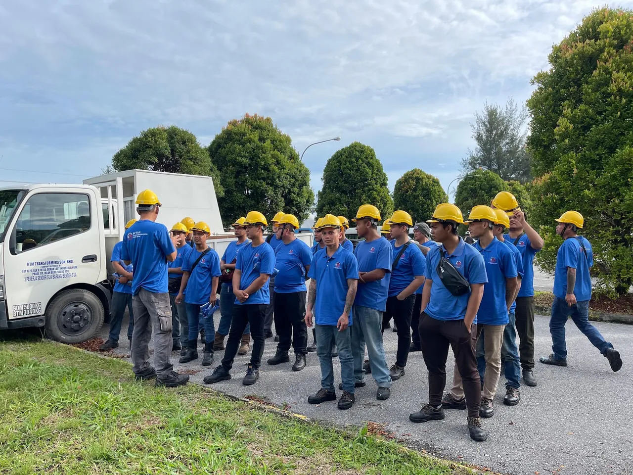 The KTM Transformers field crew assembled beside a service vehicle before a site job.