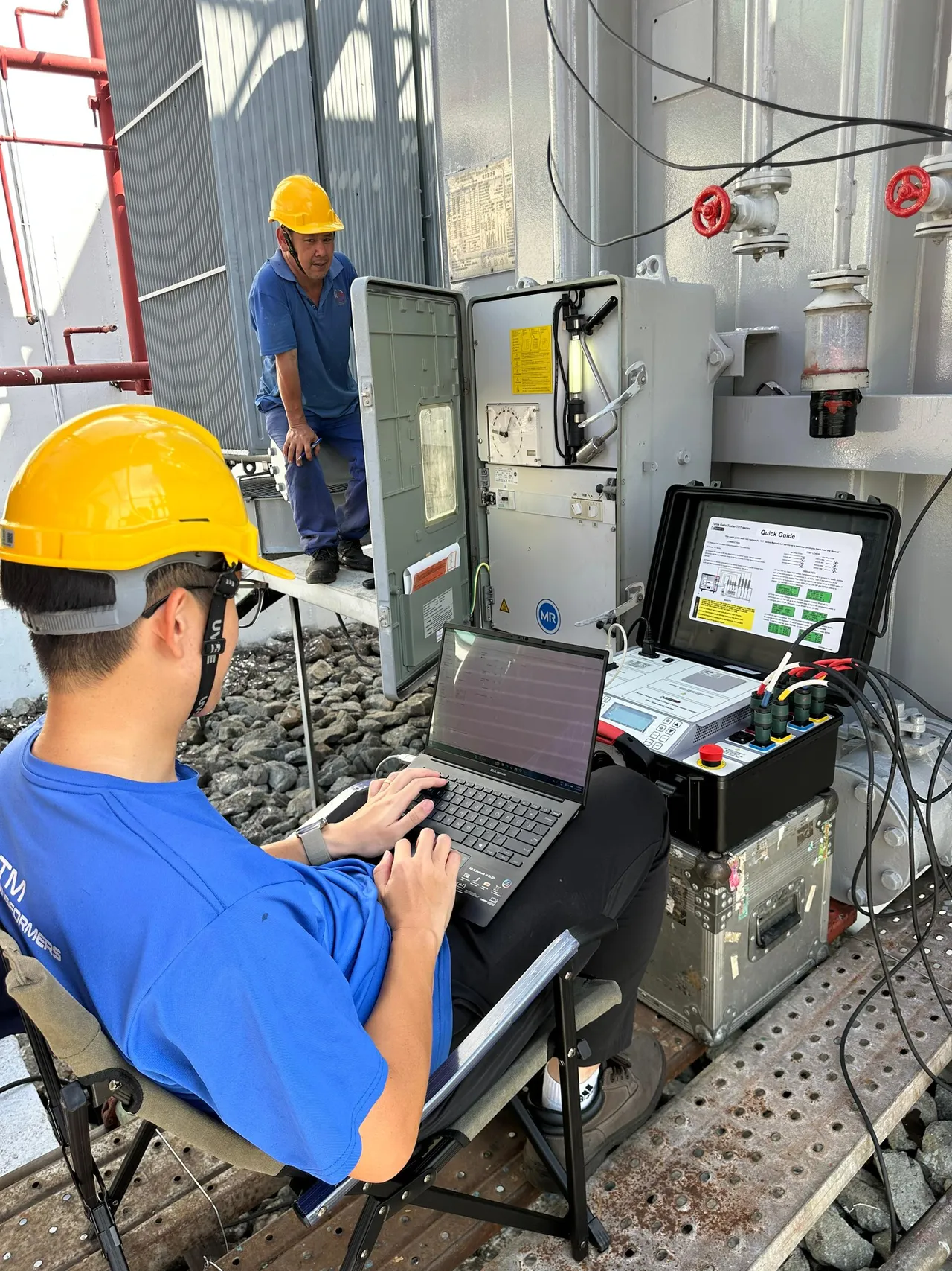A KTM Transformers engineer running diagnostic tests on a power transformer.