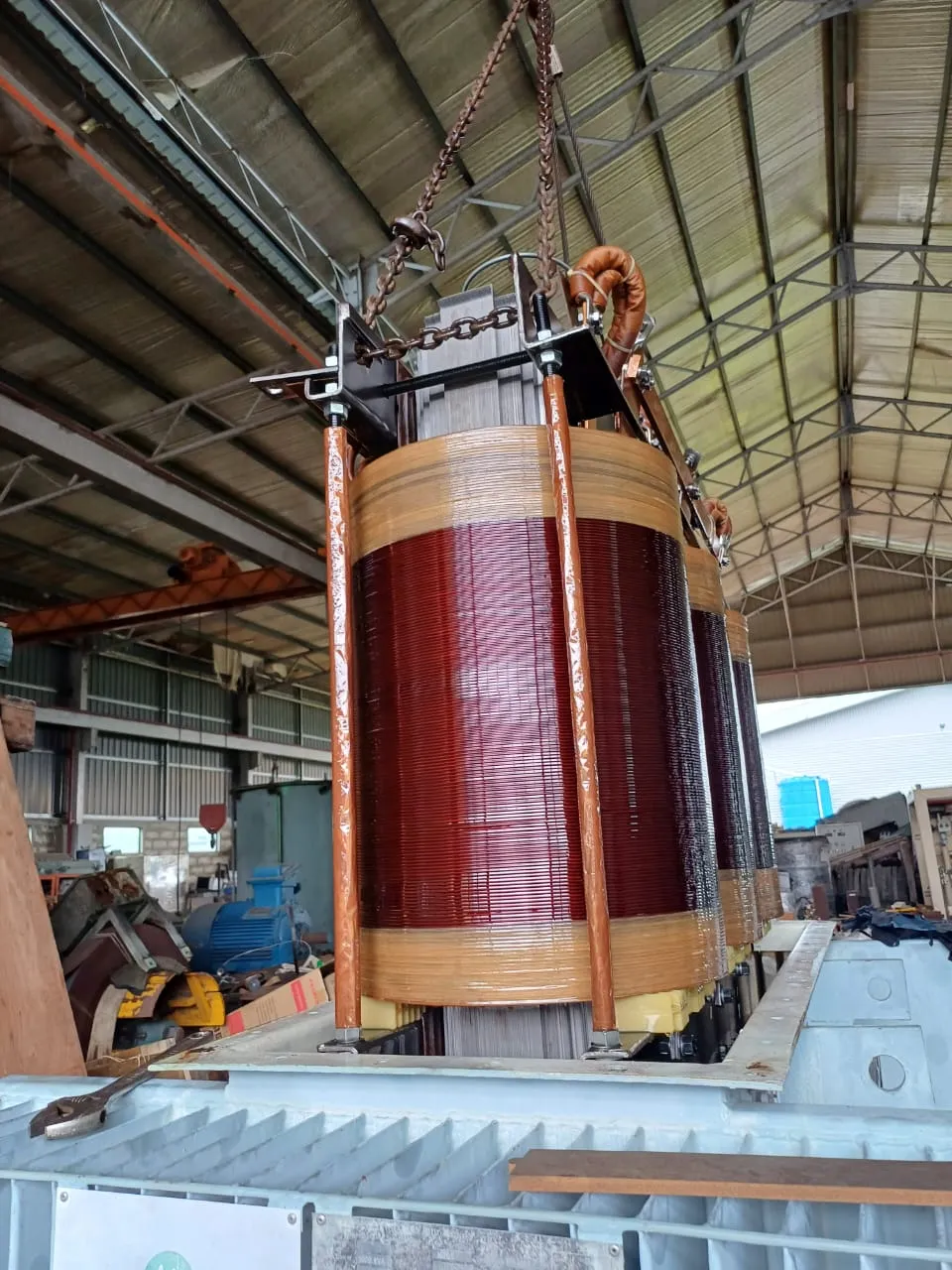 A transformer winding being lifted during overhaul at the KTM workshop.