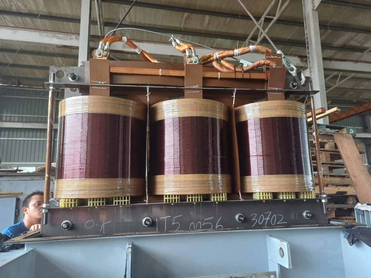 Three-phase transformer windings during refurbishment.